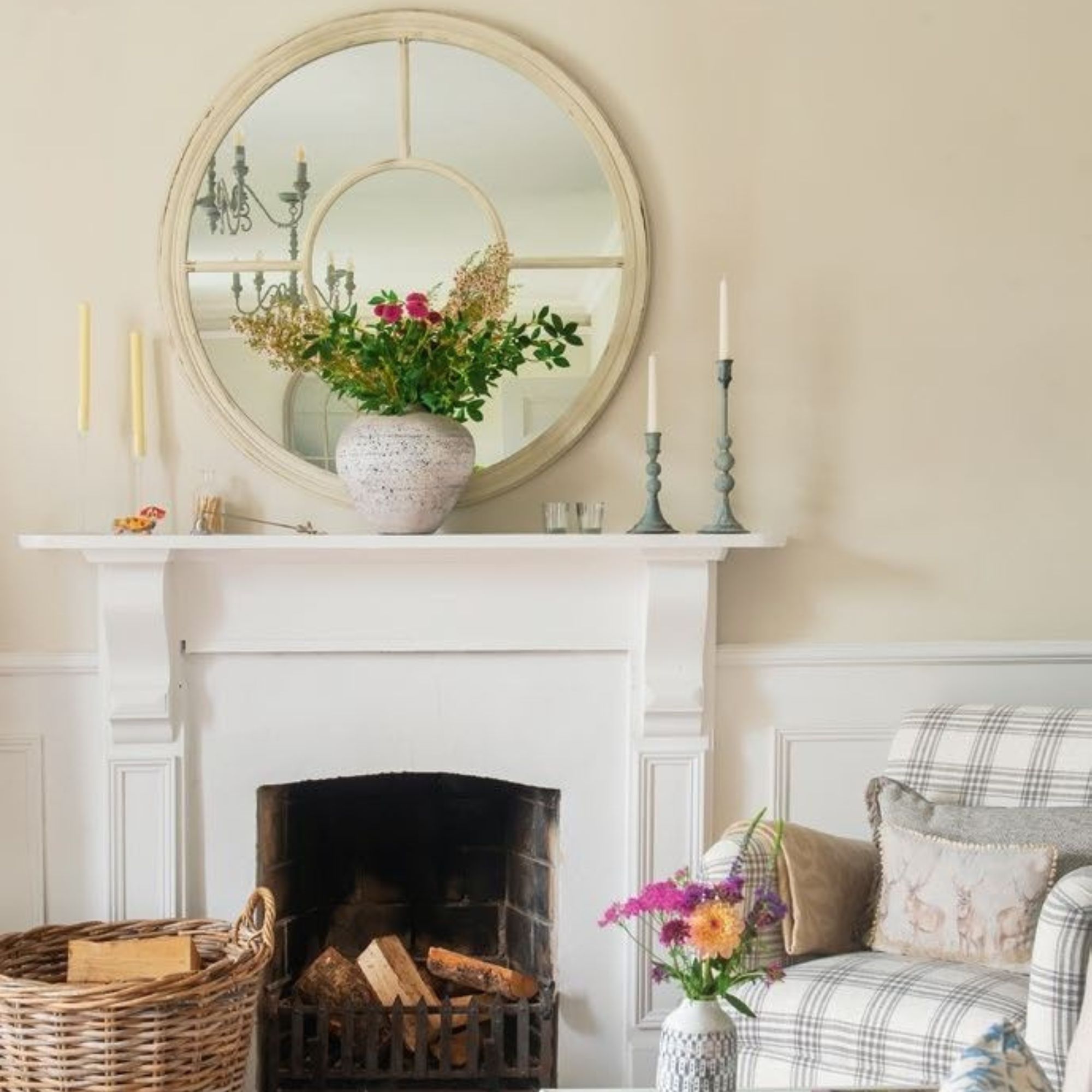 Cottage with white fireplace, panelling, striped armchair and large mirror