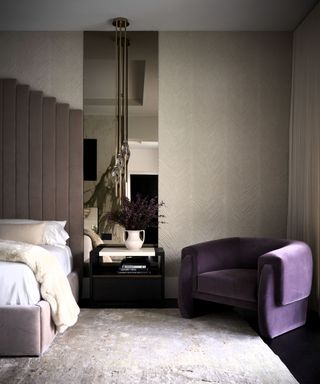 Neutral bedroom with purple velvet chair