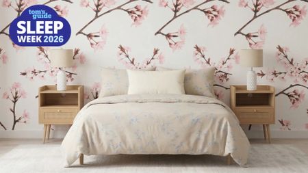 A Feng Shui Bedroom with a cherry blossom wallpaper and matching nightstands and lamps for visual symmetry. A "Sleep Week 2026" badge is seen in the foreground. 
