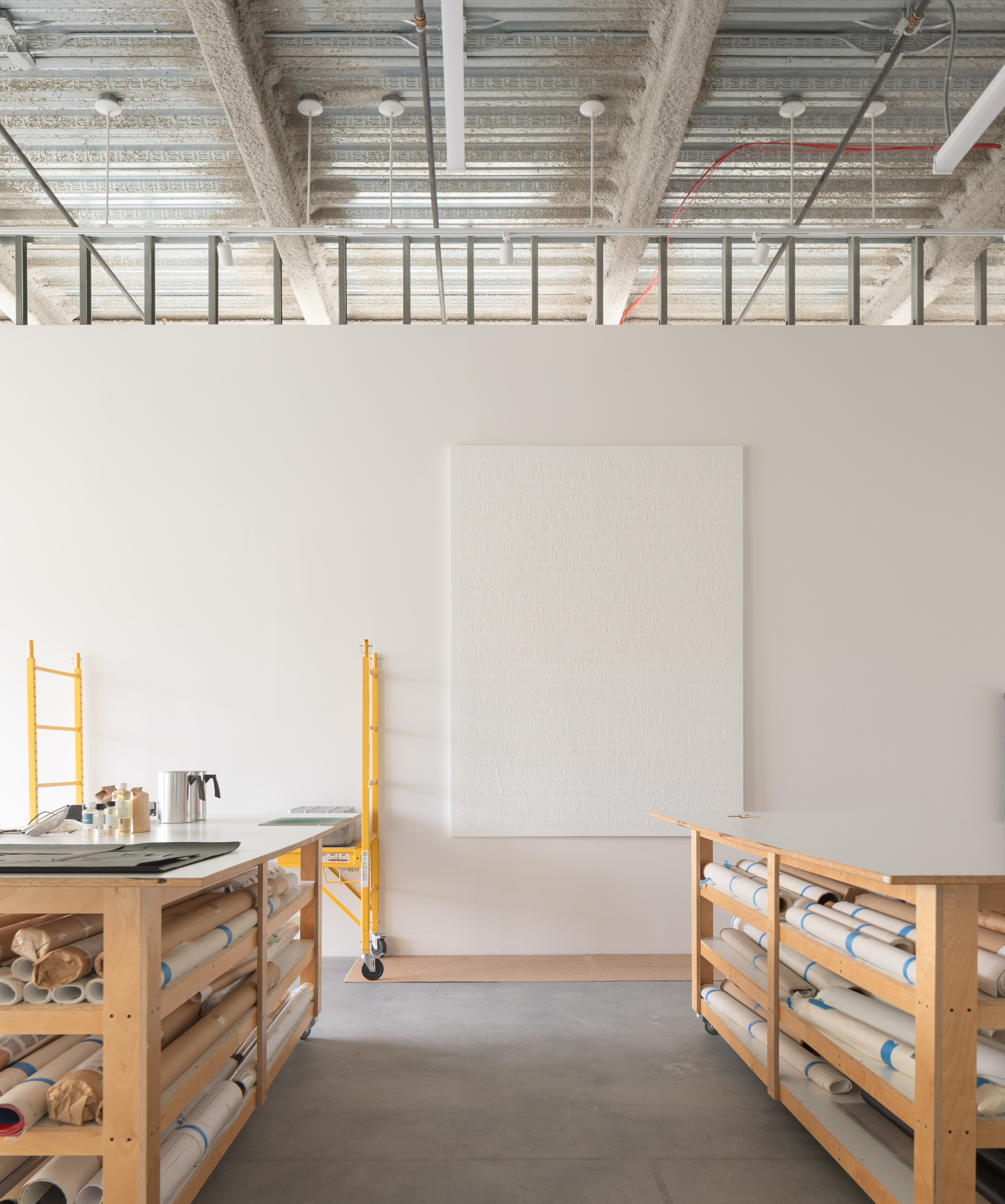 minimalist interior of artist Glenn Ligon's studio by Ravi Raj, with artworks and bespoke utilitarian furniture