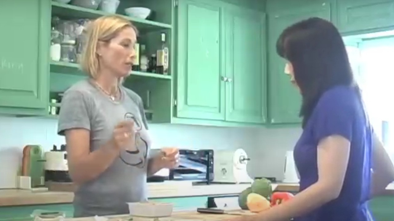 Tamra Davis cooking a meal with a friend on her cooking show
