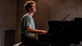 ANDREW GARFIELD as JONATHAN LARSON playing the piano in Tick Tick...Boom!