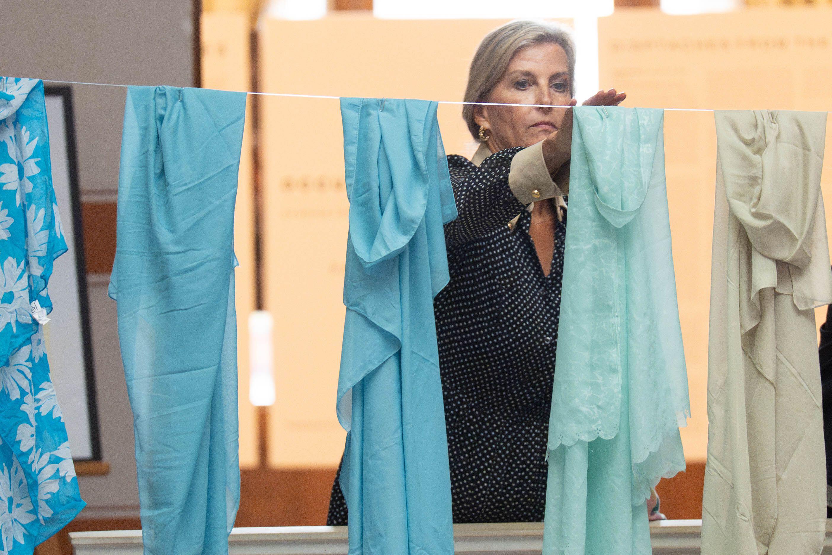 Duchess Sophie hanging a scarf on a clothes line at a memorial in Bosnia