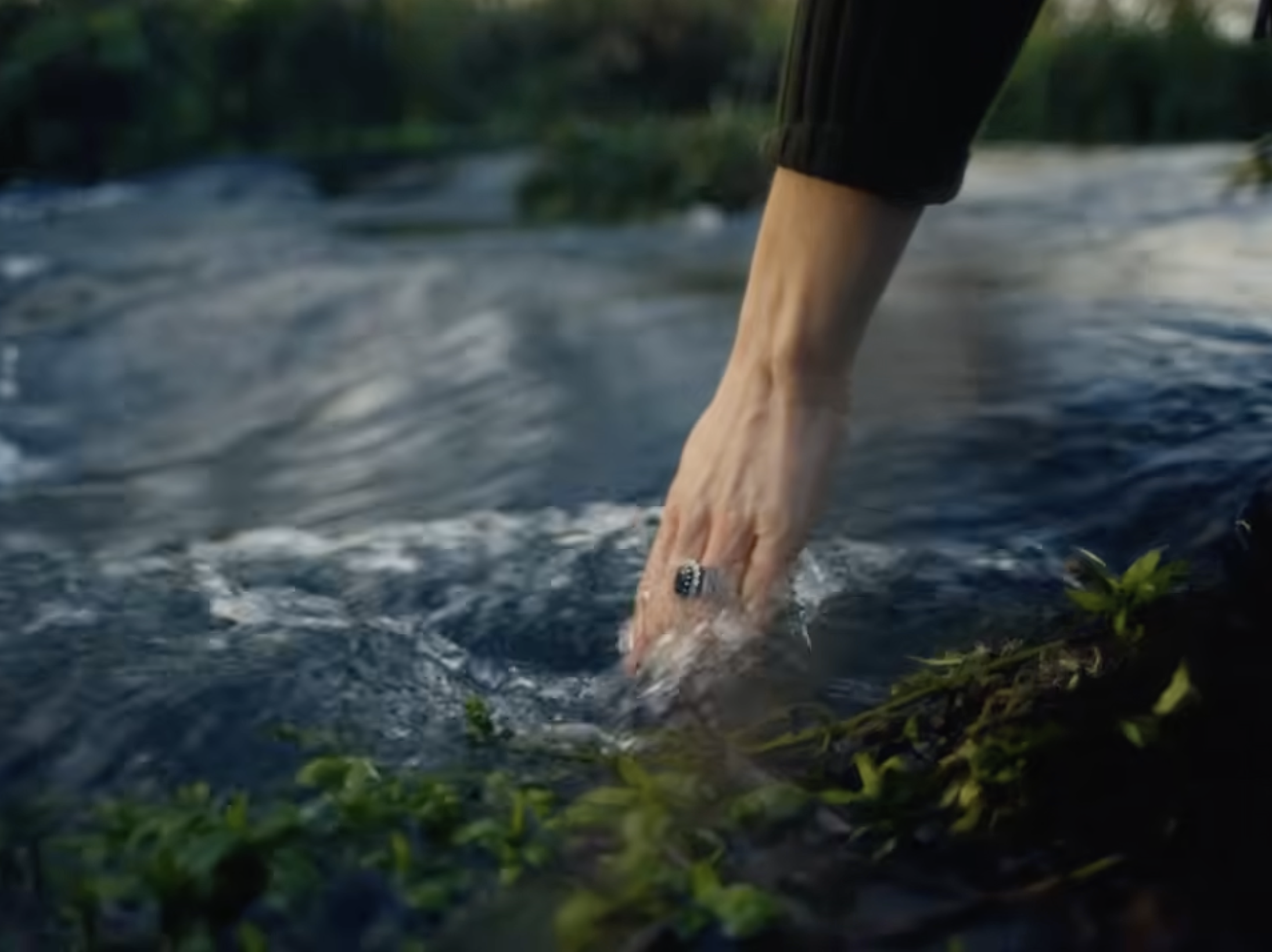 Princess Kate sticking her hand in a stream