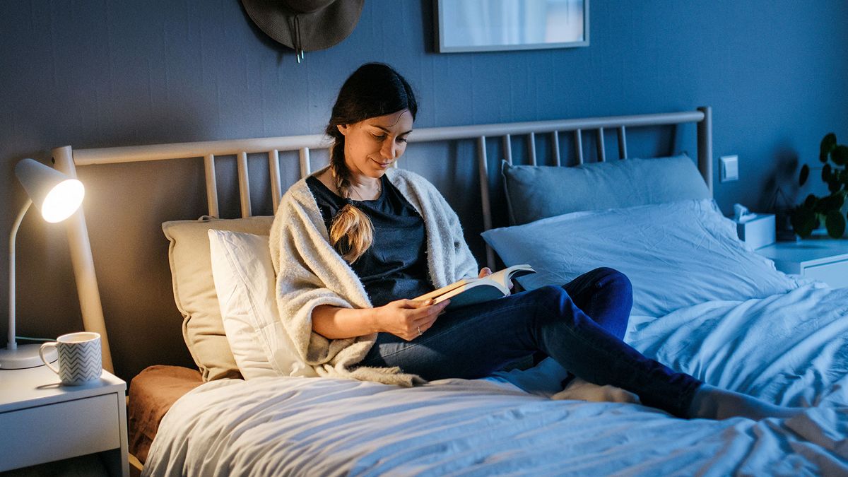 Woman reading a book in bed