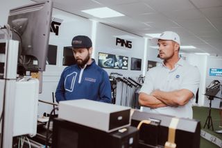 Bryson Dechambeau analysing club specifictions with a master club fitter at Scottsdale Golf