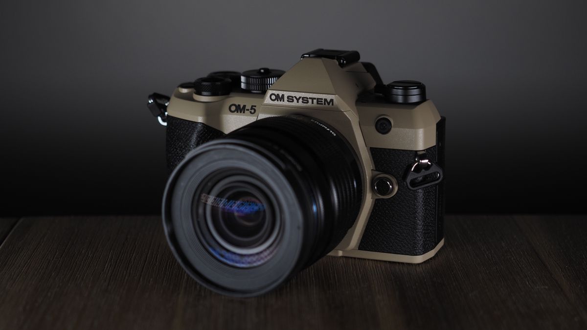 OM System OM-5 Mark II on a wooden surface with an Olympus M.Zuiko 12-45mm lens