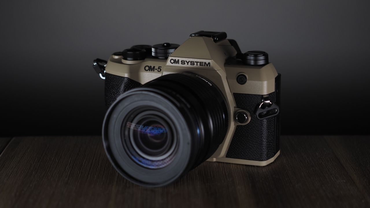 OM System OM-5 Mark II on a wooden surface with an Olympus M.Zuiko 12-45mm lens