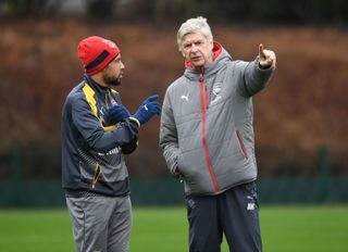 Arsenal manager Arsene Wenger talks with Francis Coquelin during a training session at London Colney on March 3, 2017 in St Albans, England.