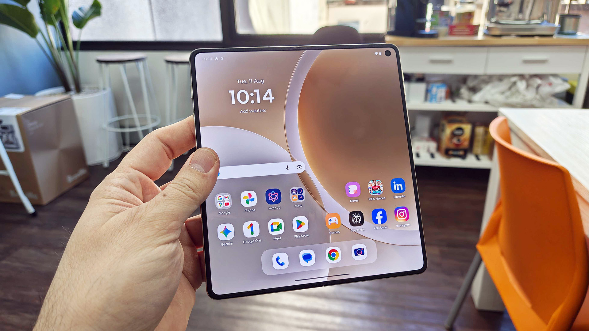 In-hand image of the Motorola Razr Fold in unfolded mode