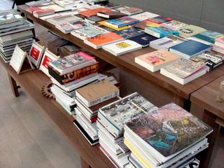 books in booshop categorised in piles