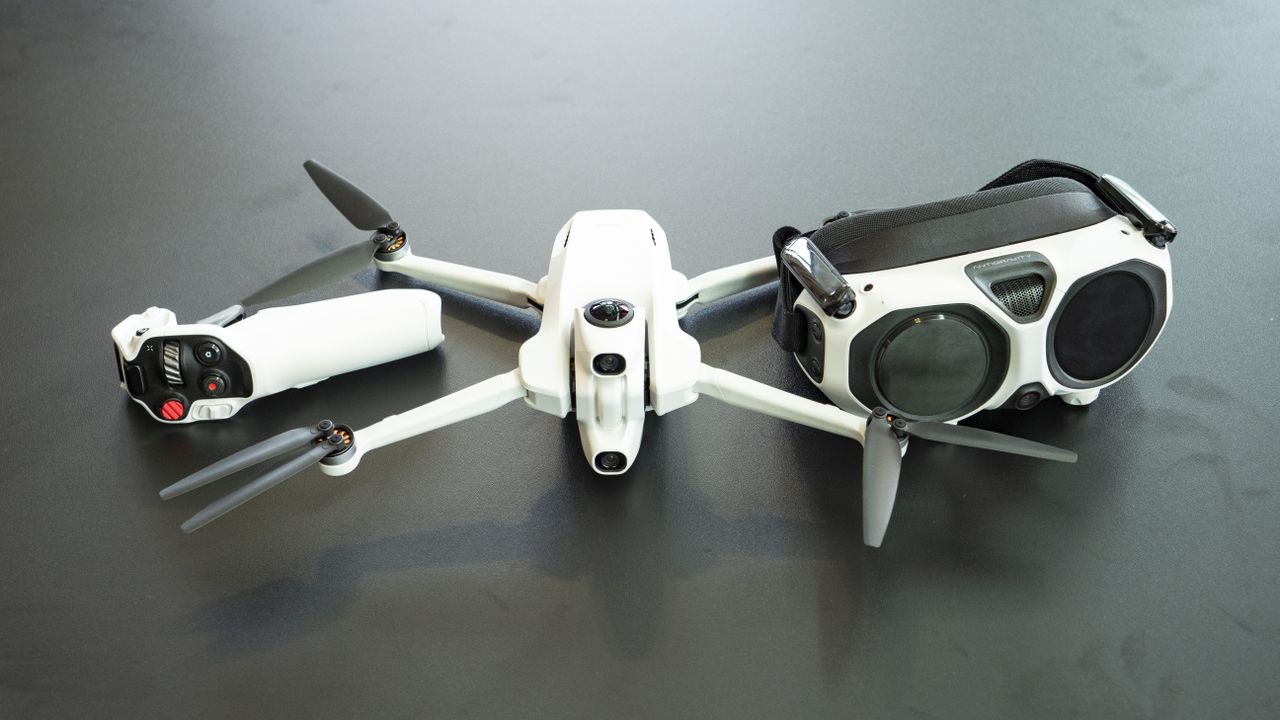 Antigravity A1 drone by Insta360 alongside its headset and controller, on a black table