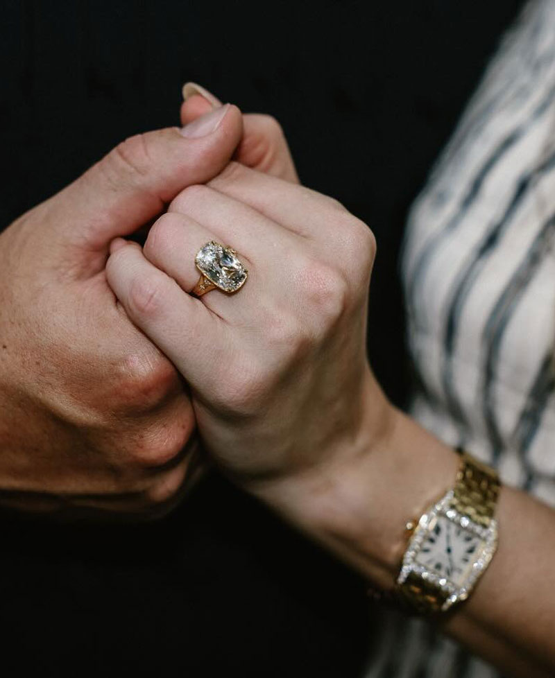 Taylor Swift wearing a gold watch in her engagement announcement.