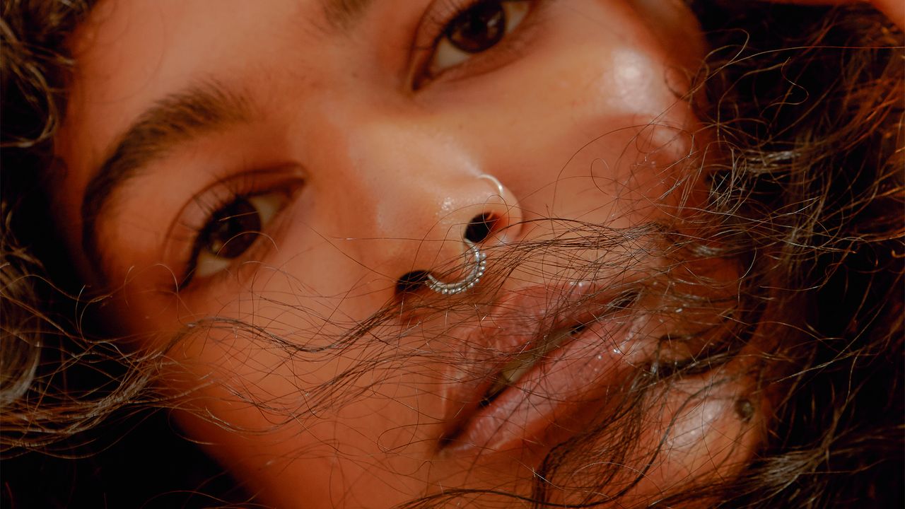 close-up of woman&#039;s face with nose ring