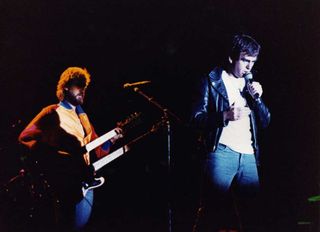 Mike Rutherford and Peter Gabriel onstage in Milton Keynes in 1982