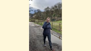 Samantha Priestley swinging her arms while power walking across the countryside
