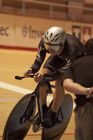 New Zealand's Shane Archbold is watched closely by his coach as he heads towards gold in the men's omnium.