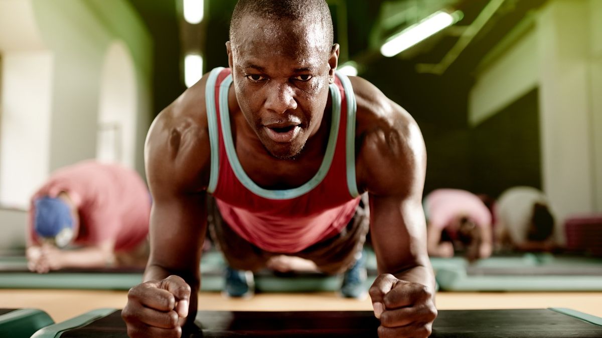 Sweaty man in plank position