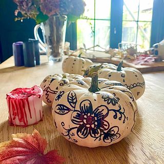 White pumpkins with pattern drawn on in marker pen