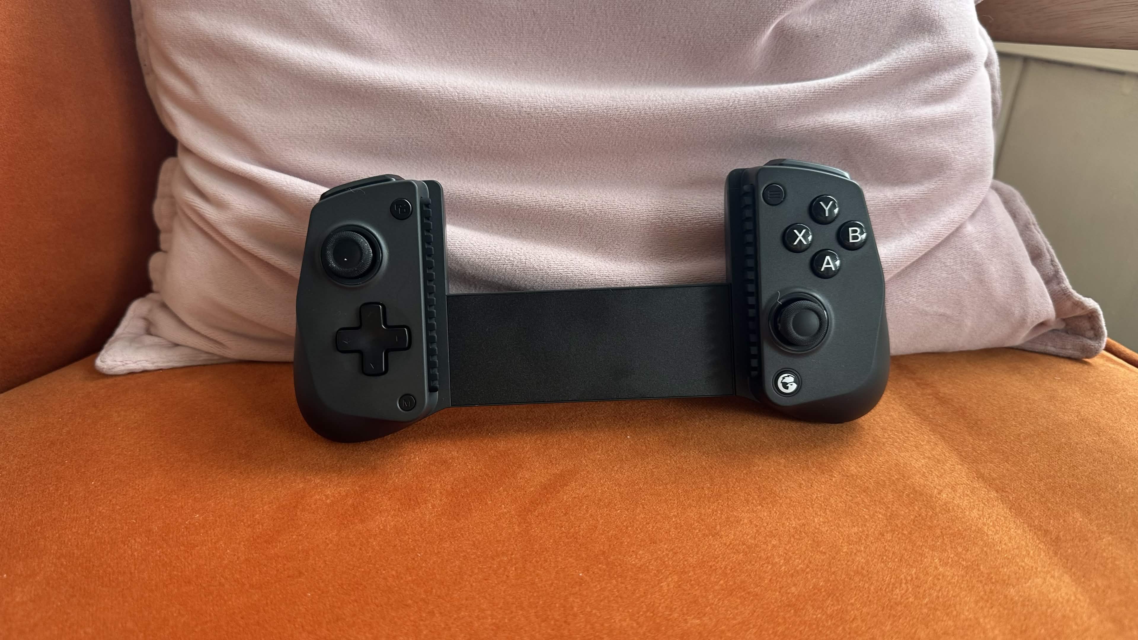 The GameSir X5s on a small living room chair