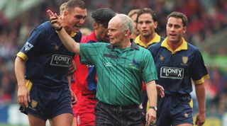17 SEP 1994: WIMBLEDON CAPTAIN VINNIE JONES (LEFT) SHOWS HIS ANGER TOWARD THE REFEREE DURING THE LONDON DERBY BETWEEN CRYSTAL PALACE AND WIMBLEDON IN THE ENGLISH PREMIER LEAGUE