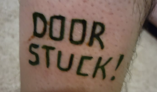 A tattoo of the words 'Door Stuck' on a chap's leg.