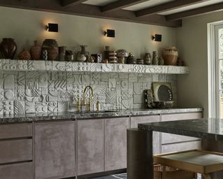 kitchen with high relief backsplash tiles and venetial plaster finish cabinets