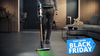 A Tom&#039;s Guide Black Friday deal label on an image of a person using the Dyson Gen5detect with Fluffy Optic in a living room