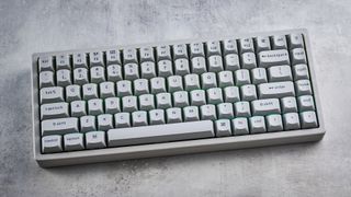 The Keychron K2 HE in concrete, on a stone surface.