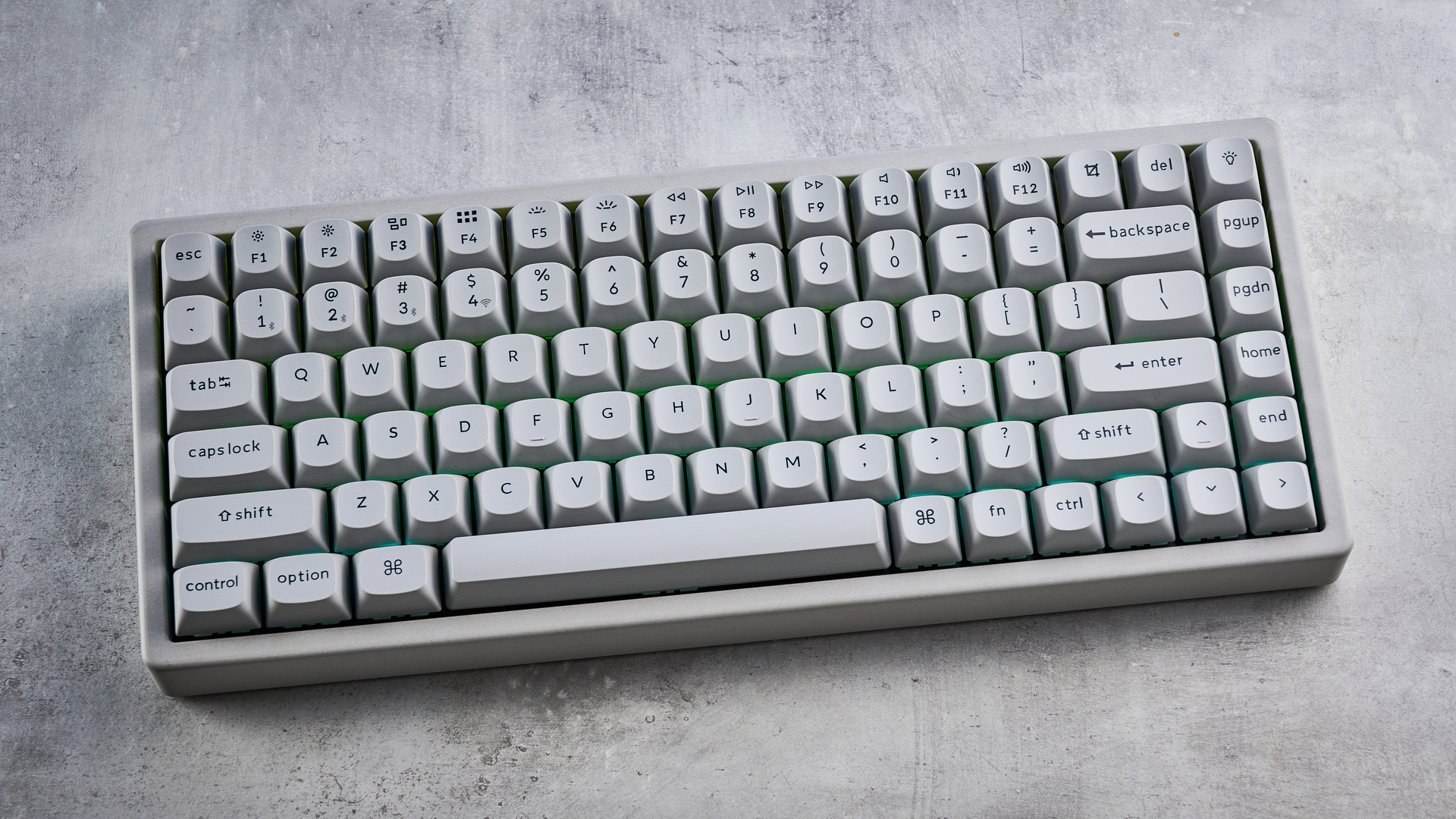 The Keychron K2 HE in concrete, on a stone surface.