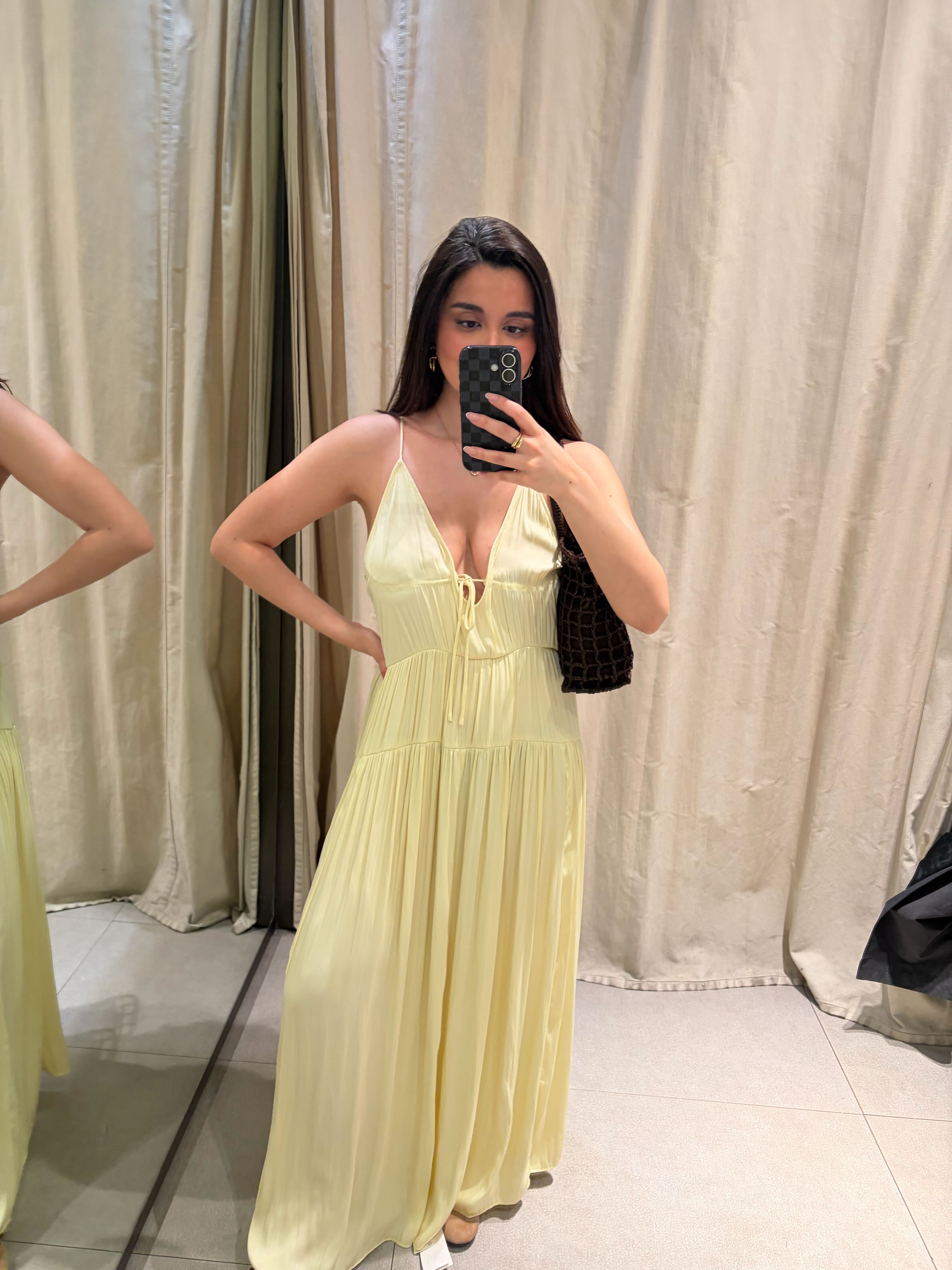 Marina wearing a butter yellow dress