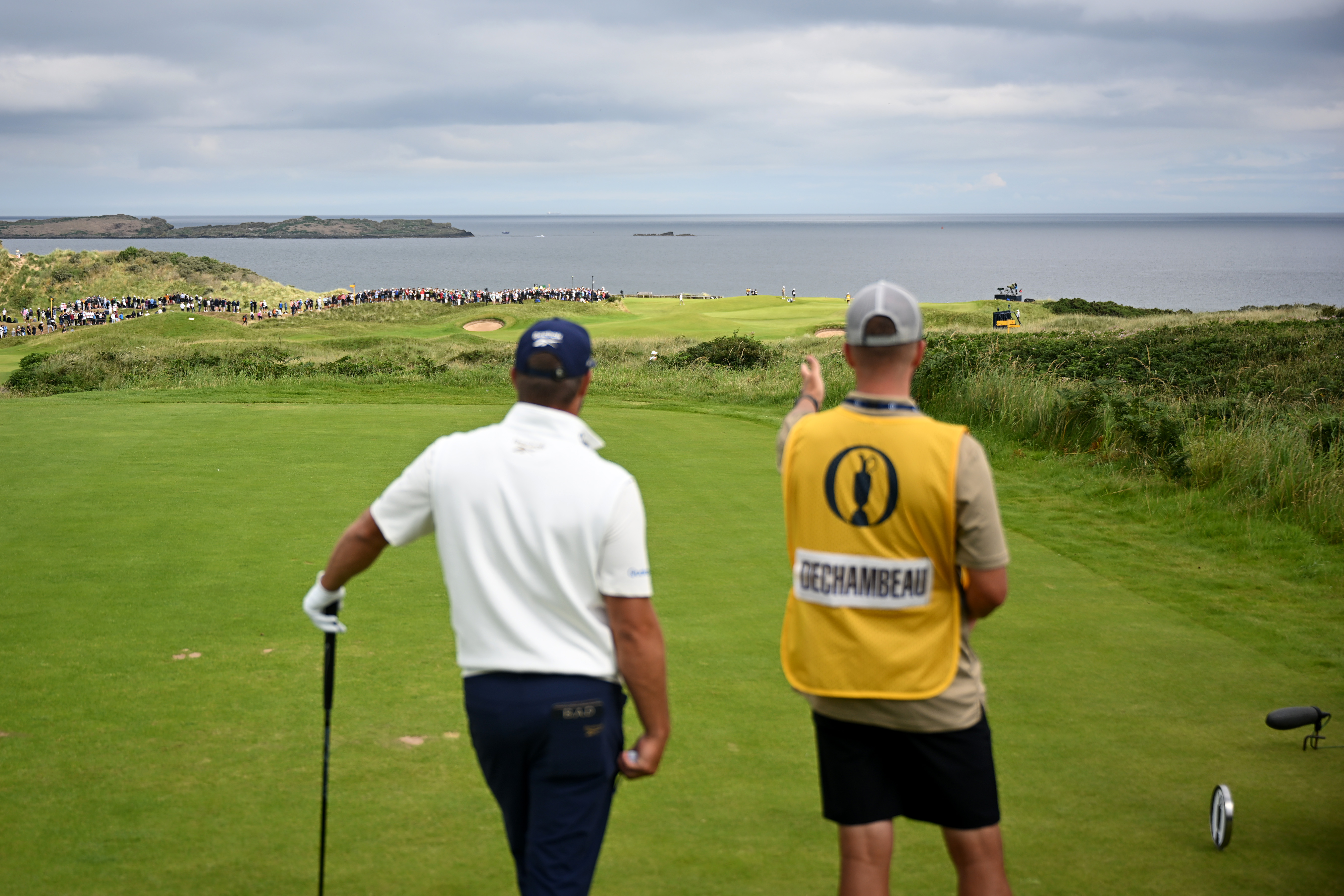 Bryson DeChambeau chats to his caddie
