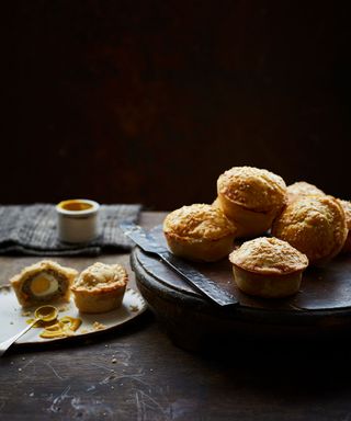 Mint Lamb And Egg Pies, plate of pies, with a single pie cut open with a boiled egg inside