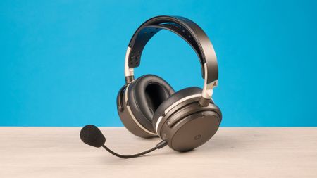 The Audeze Maxwell 2 ANC on a wooden desk with a blue background