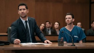 Manuel Garcia-Rulfo as Mickey Haller, Devon Graye as Julian La Cosse sitting behind a courtroom table in The Lincoln Lawyer.