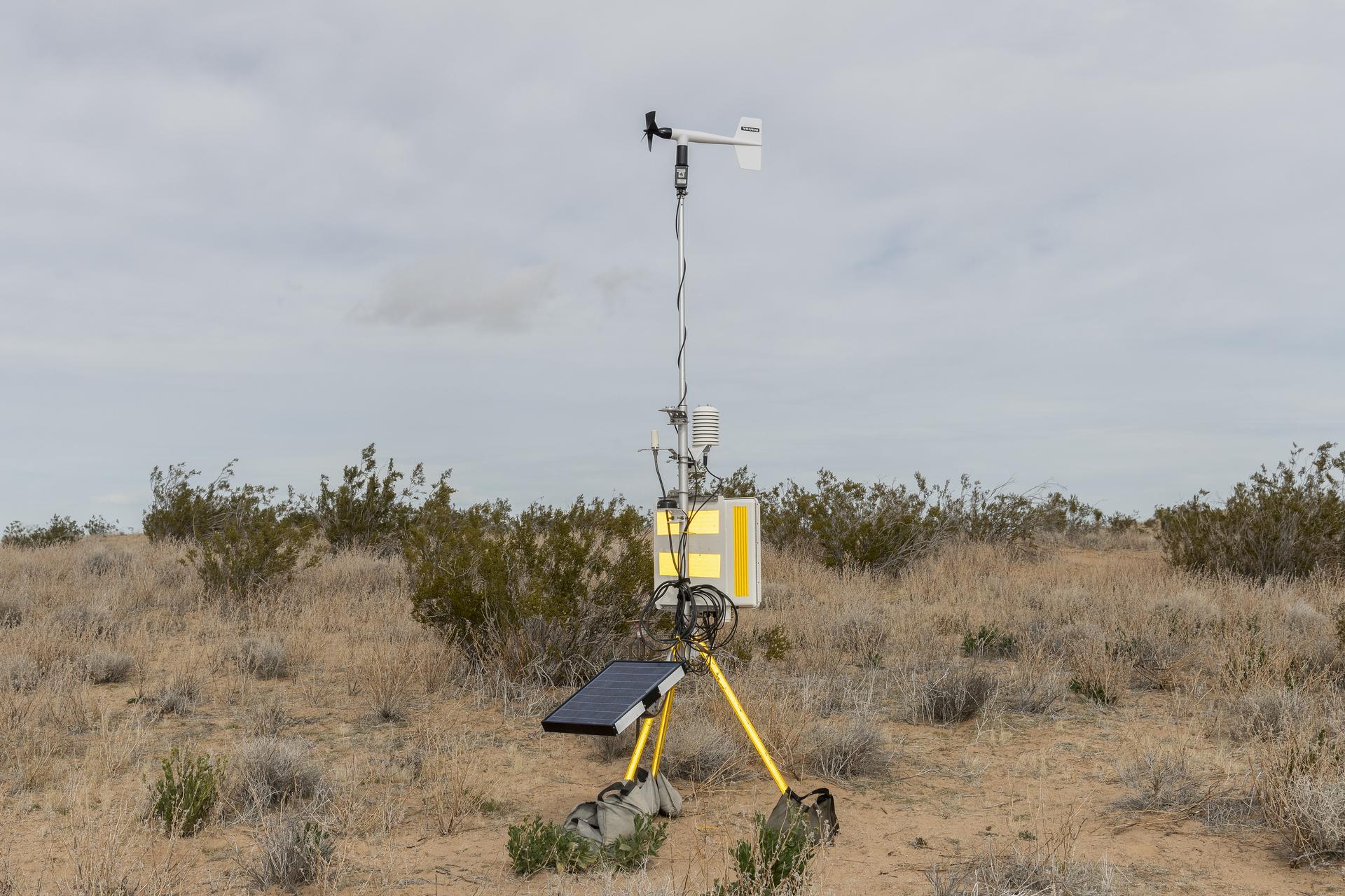 microphones and wind gauges connected to solar panels in the desert