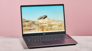 Acer Chromebook Plus 516 open on desk with pink background