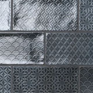A square of dark gray patterned subway tiles