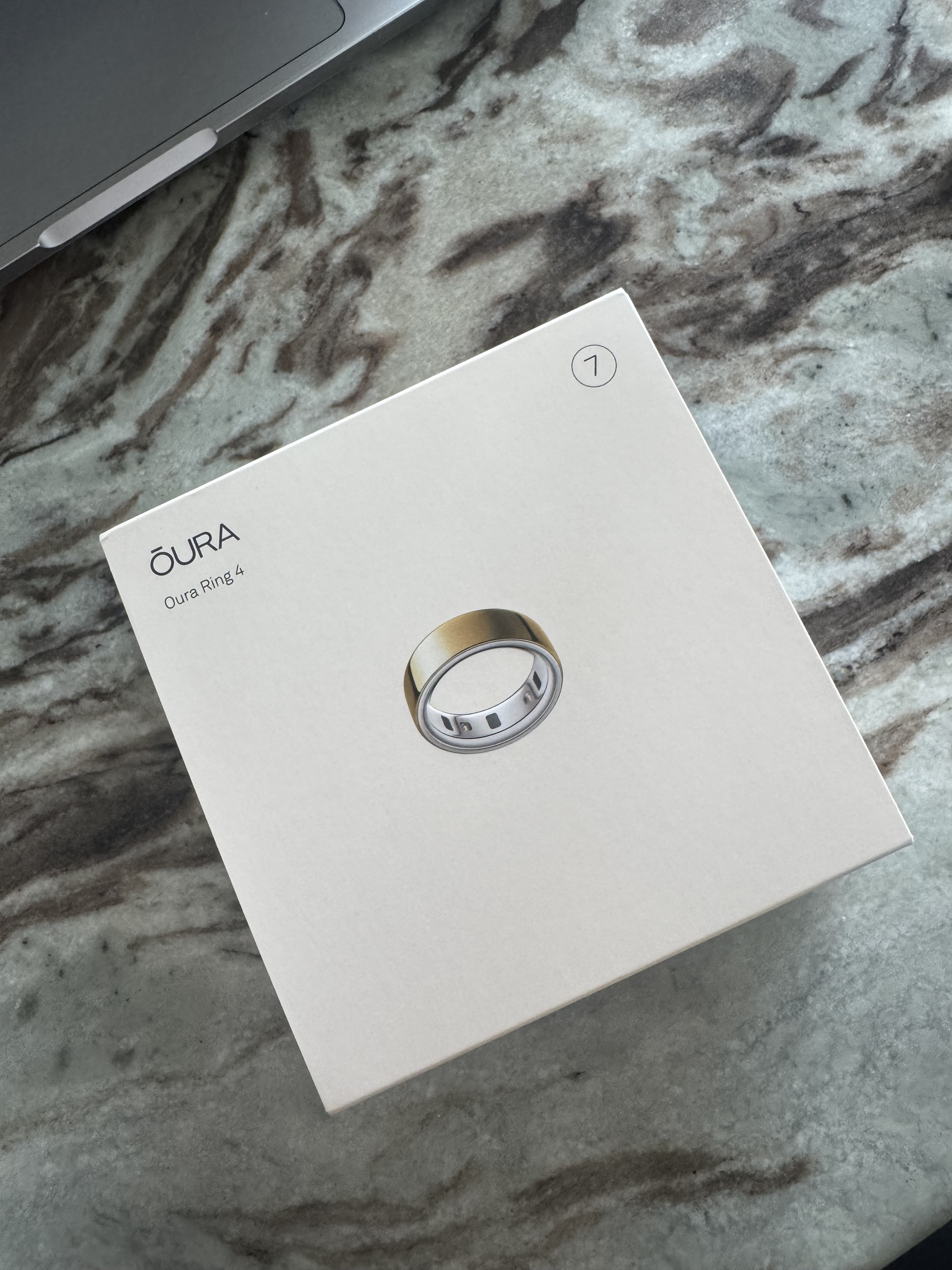 A photo of the Oura Ring 4 box on a marble table