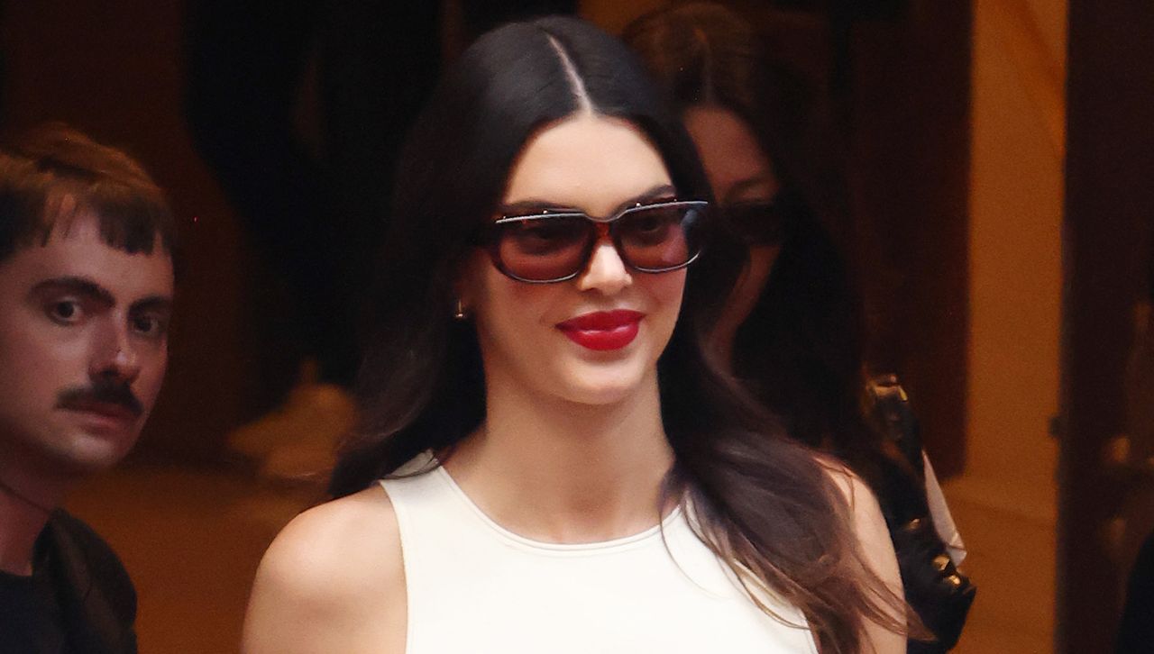 Kendall Jenner wearing a white tank top red lip and tinted sunglasses in Paris