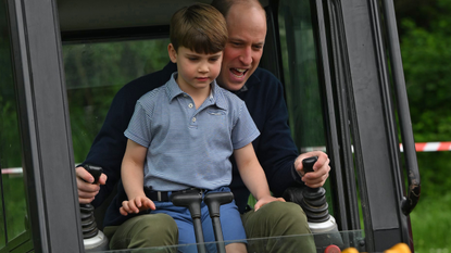 Prince William, Prince of Wales is helped by Prince Louis of Wales