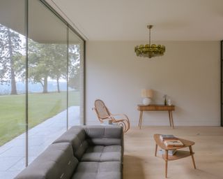 capability house with minimalist interiors of stone and timber and a twisting metal staircase