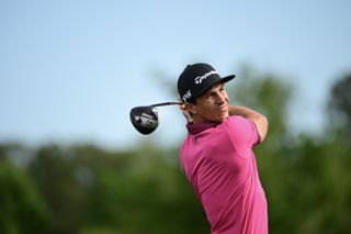 Thorbjorn Olesen hits a driver in a pink shirt