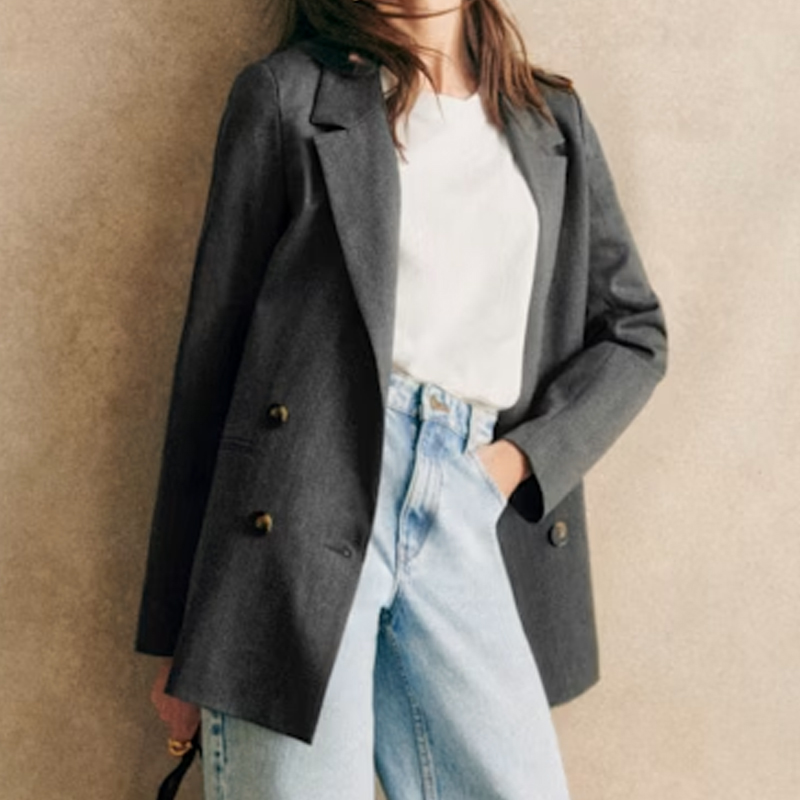 Cropped image of a model wearing a grey blazer from Sezane