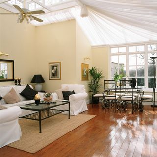 living room with white sofa and wooden flooring