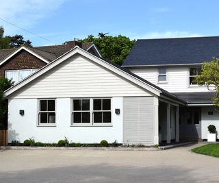 large white clad double garage conversion at front of house