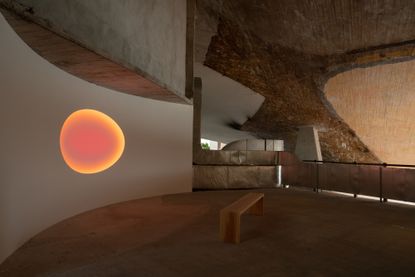 concrete ceiling and screen with light on: concrete ceiling and screen with light on – The interior space at Lago, a café, restaurant and workspace in Mexico City tour