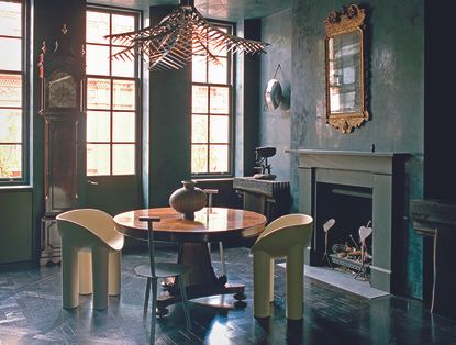 dark living room with round dining table and modern chairs