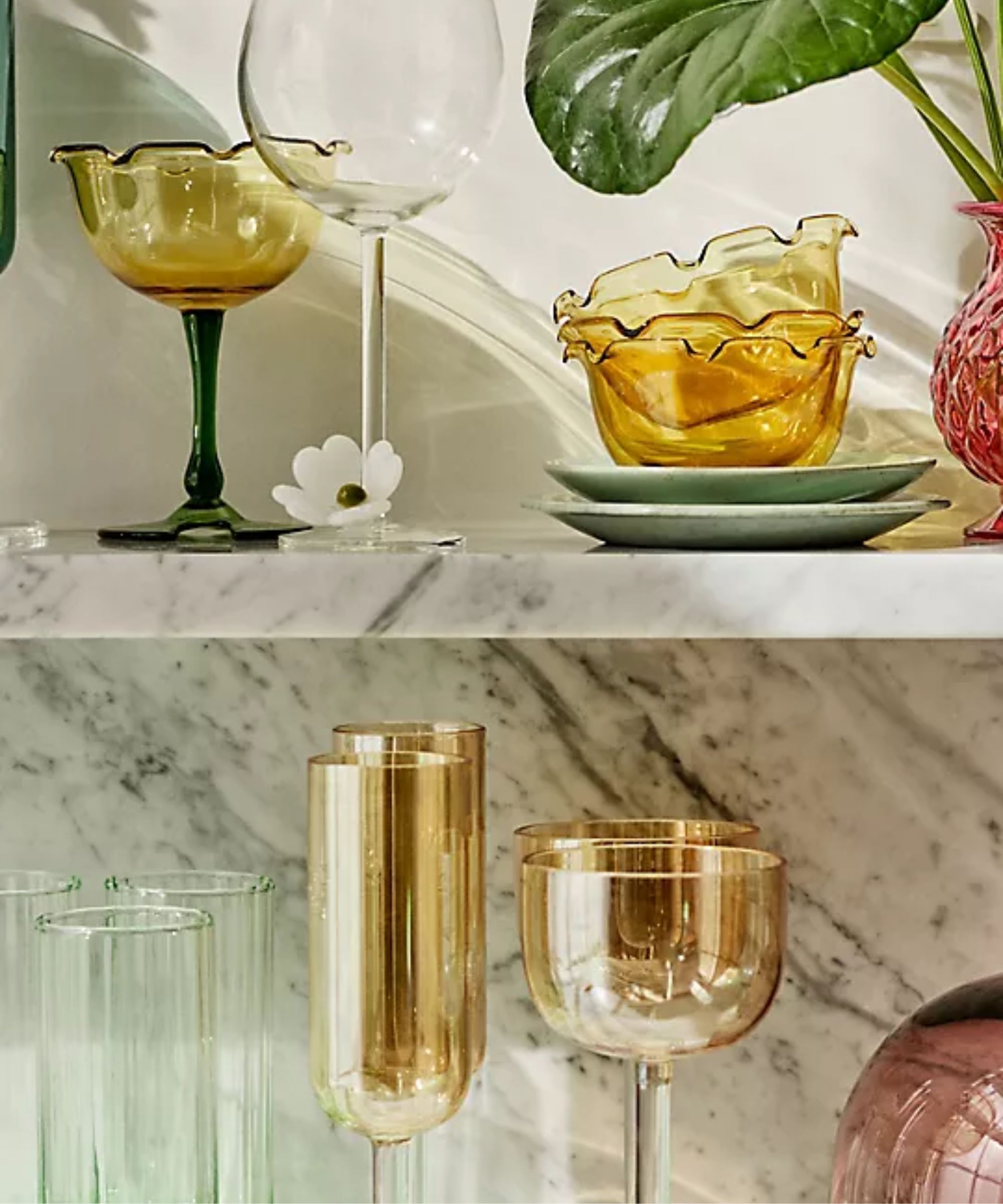 Marble shelf with gold coupe glasses, gold flutes, and lilypad-shaped coupe glasses