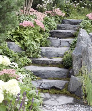 Slate stone steps in a rock garden designed by KATERINA ZASUKHINA AND CARLY KERSHAW at Chelsea Flower Show 2021